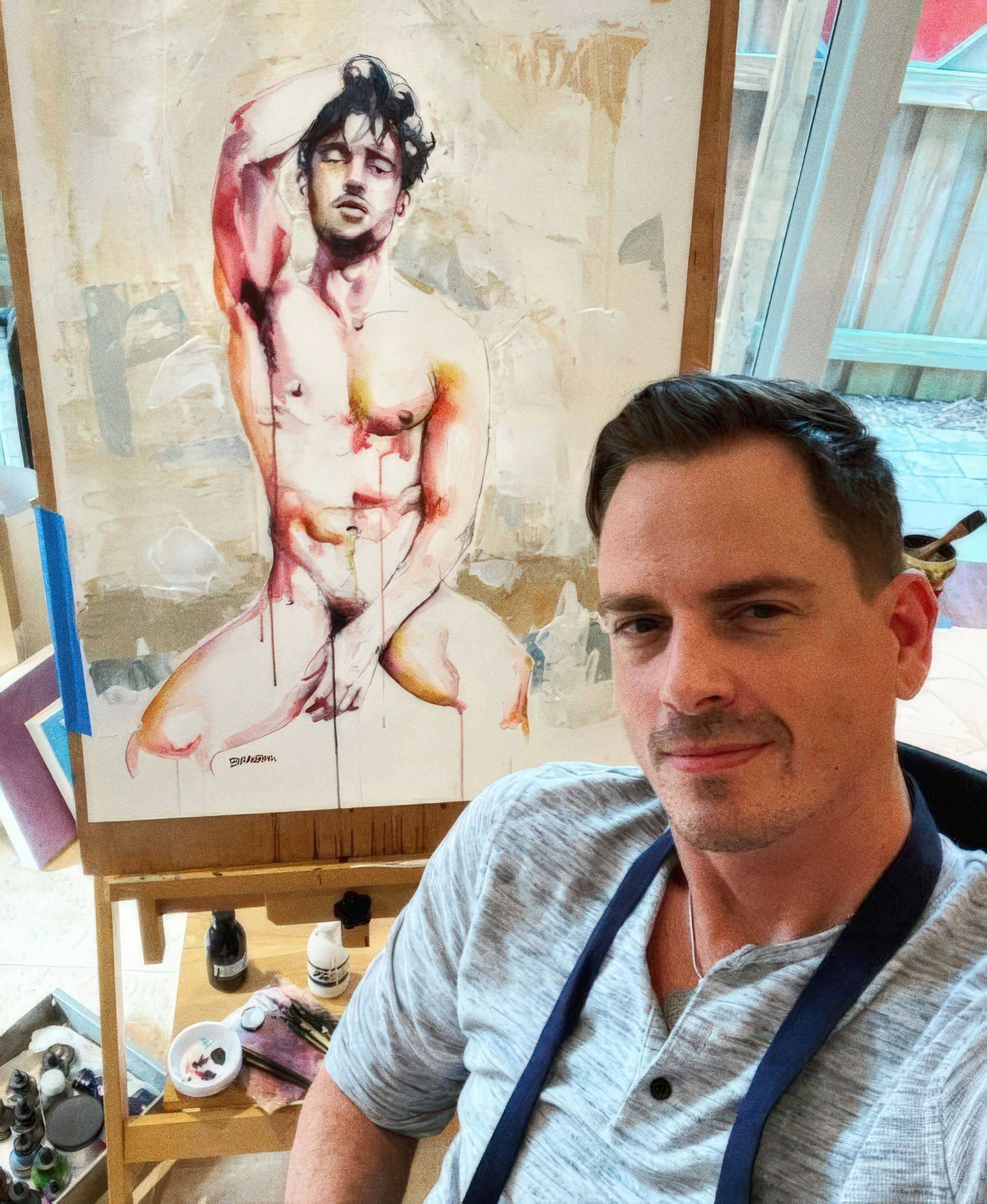 contemporary male figure artist Brenden Sanborn working in studio at easel