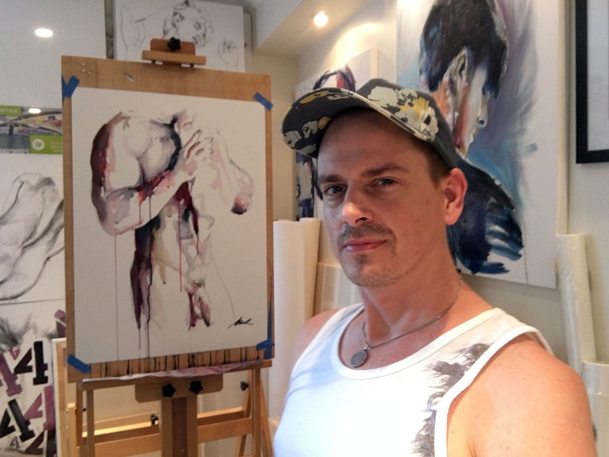 artist Brenden Sanborn in studio with powerful male nude painting on easel