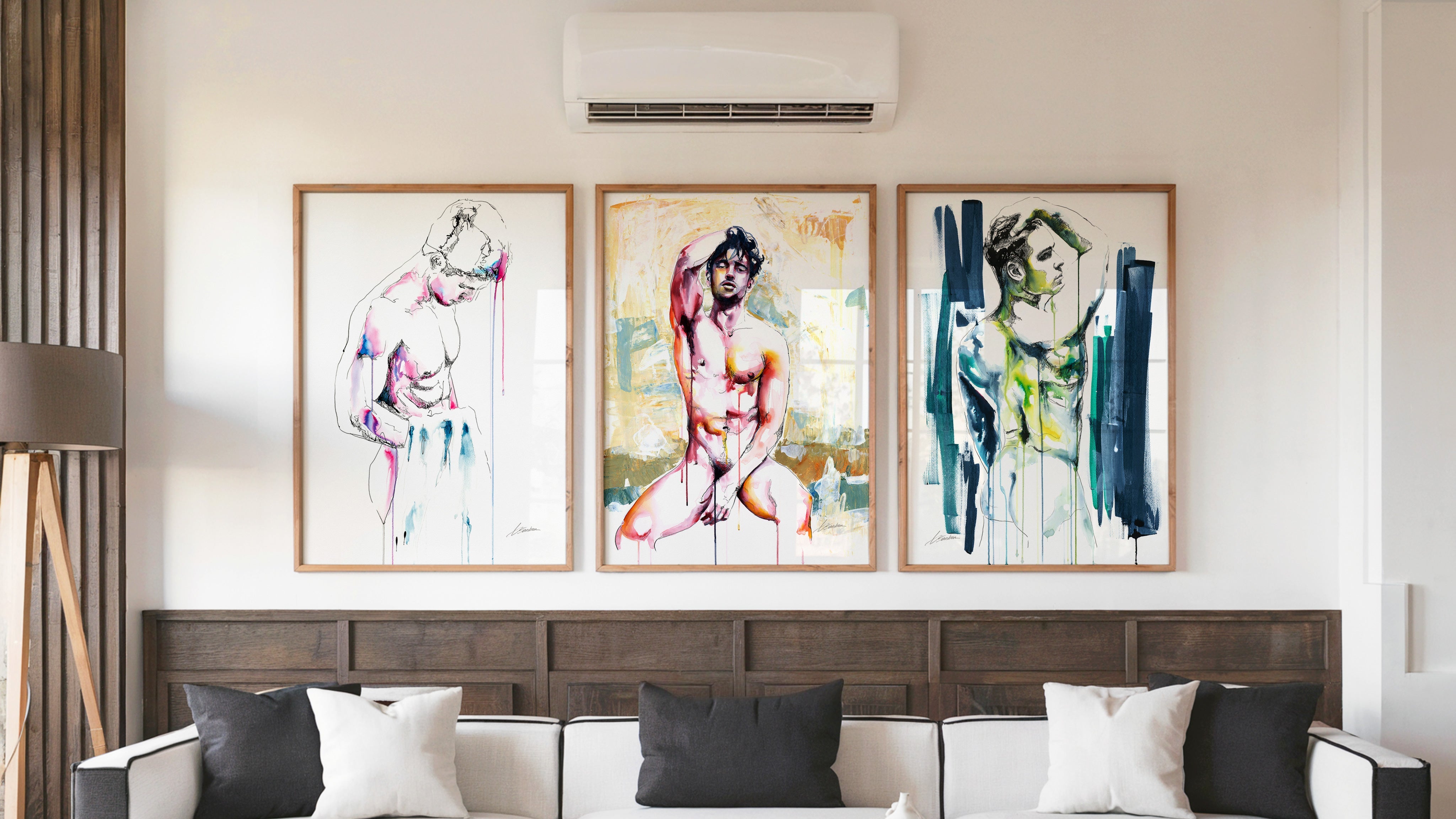 Drip watercolor male figure art prints by Brenden Sanborn displayed in a modern living room, three framed paintings above a sofa