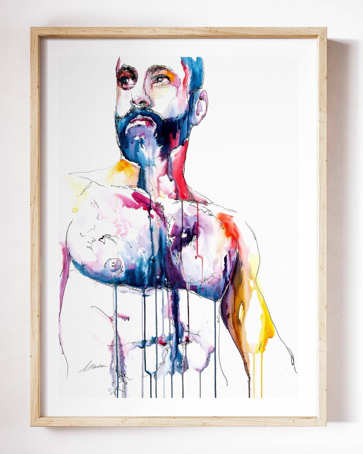 Already Decided watercolor art print by Brenden Sanborn, a bearded man looking straight at you, his chest in indigo, rose and gold, shown in a light wood frame on a white wall