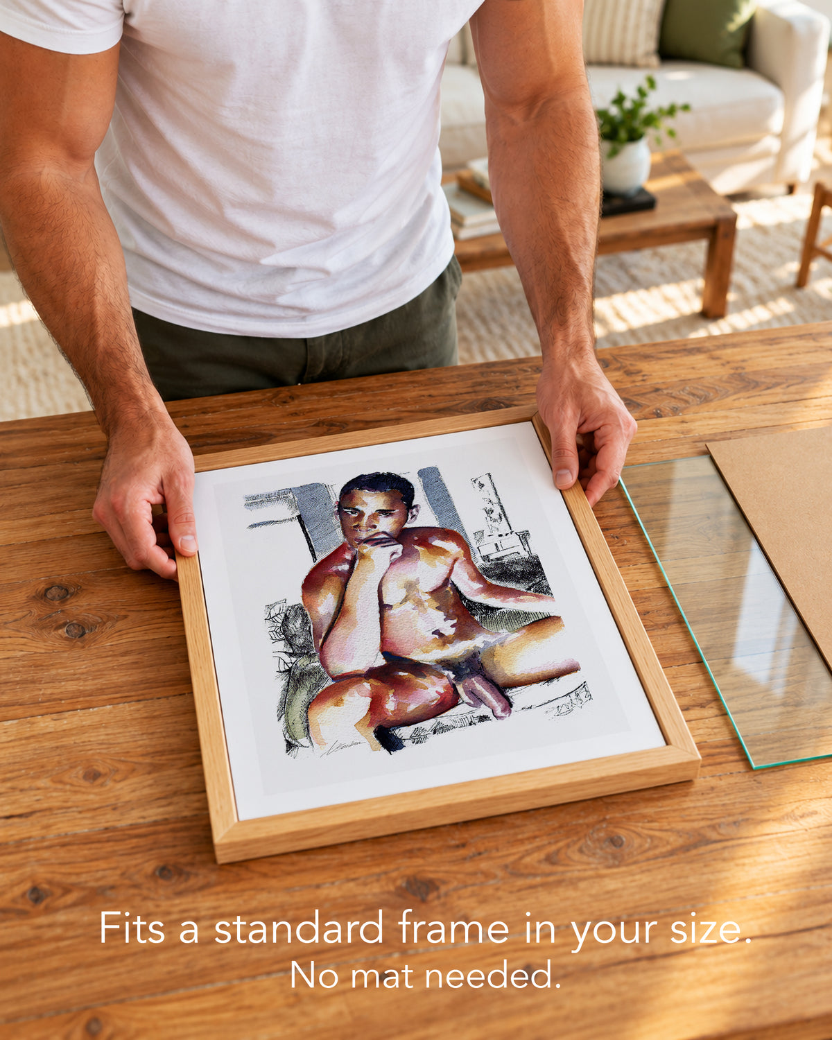 A man placing the Magnitude paper art print with a white border into a standard wood frame, no mat needed