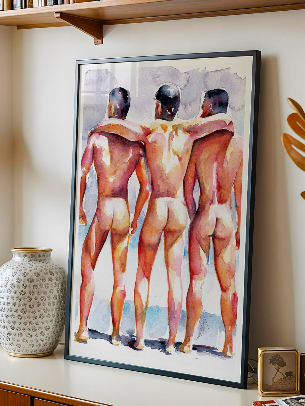 Framed watercolor print by Brenden Sanborn of three men seen from behind with their arms around each other, leaning on a shelf beside a vase