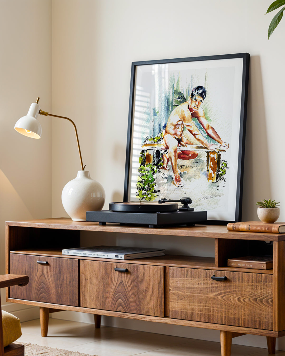 Garden Bench art print in a black frame leaning on a walnut sideboard beside a record player