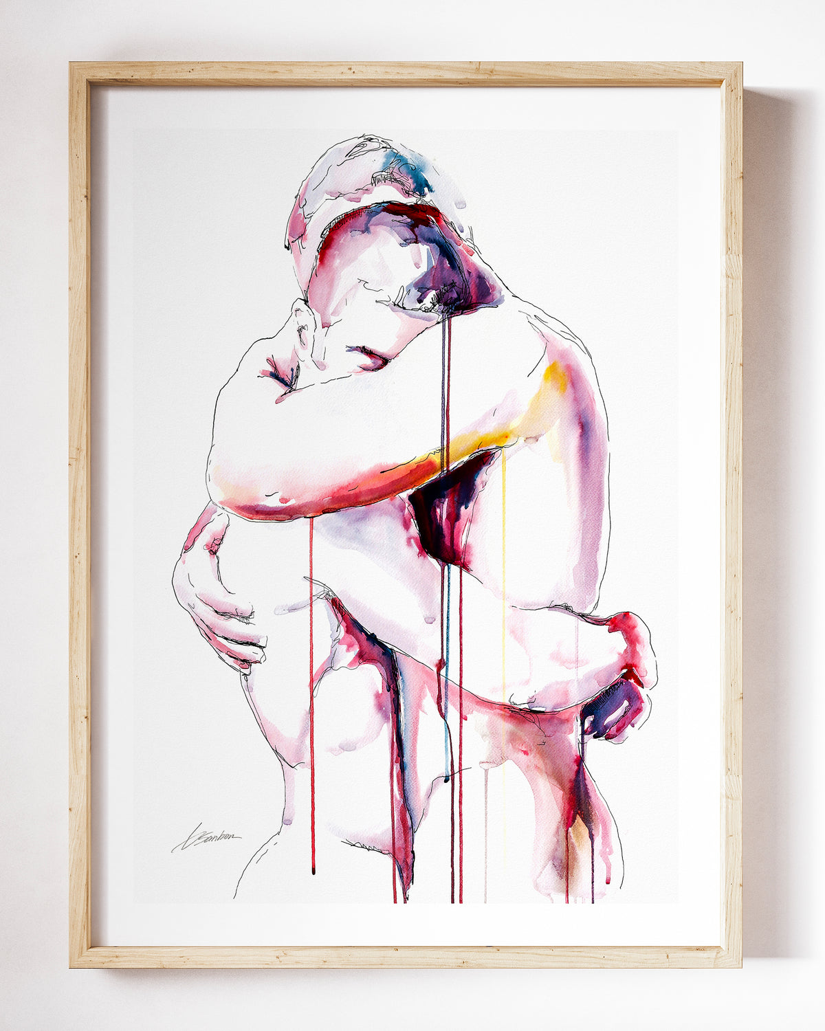 Never Let Me Go watercolor art print by Brenden Sanborn, two men folded into each other in a tight embrace, in rose and red, shown in a light wood frame on a white wall