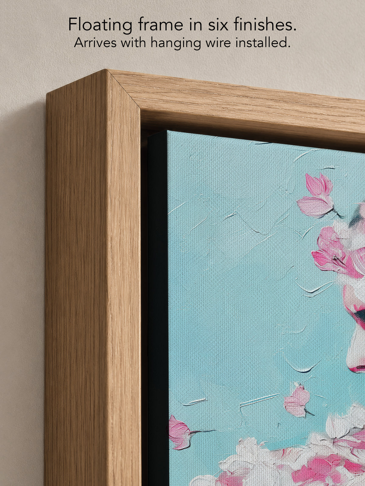 Close up corner of Rose Plaster in a natural oak floating frame, with black canvas edges and hanging wire installed