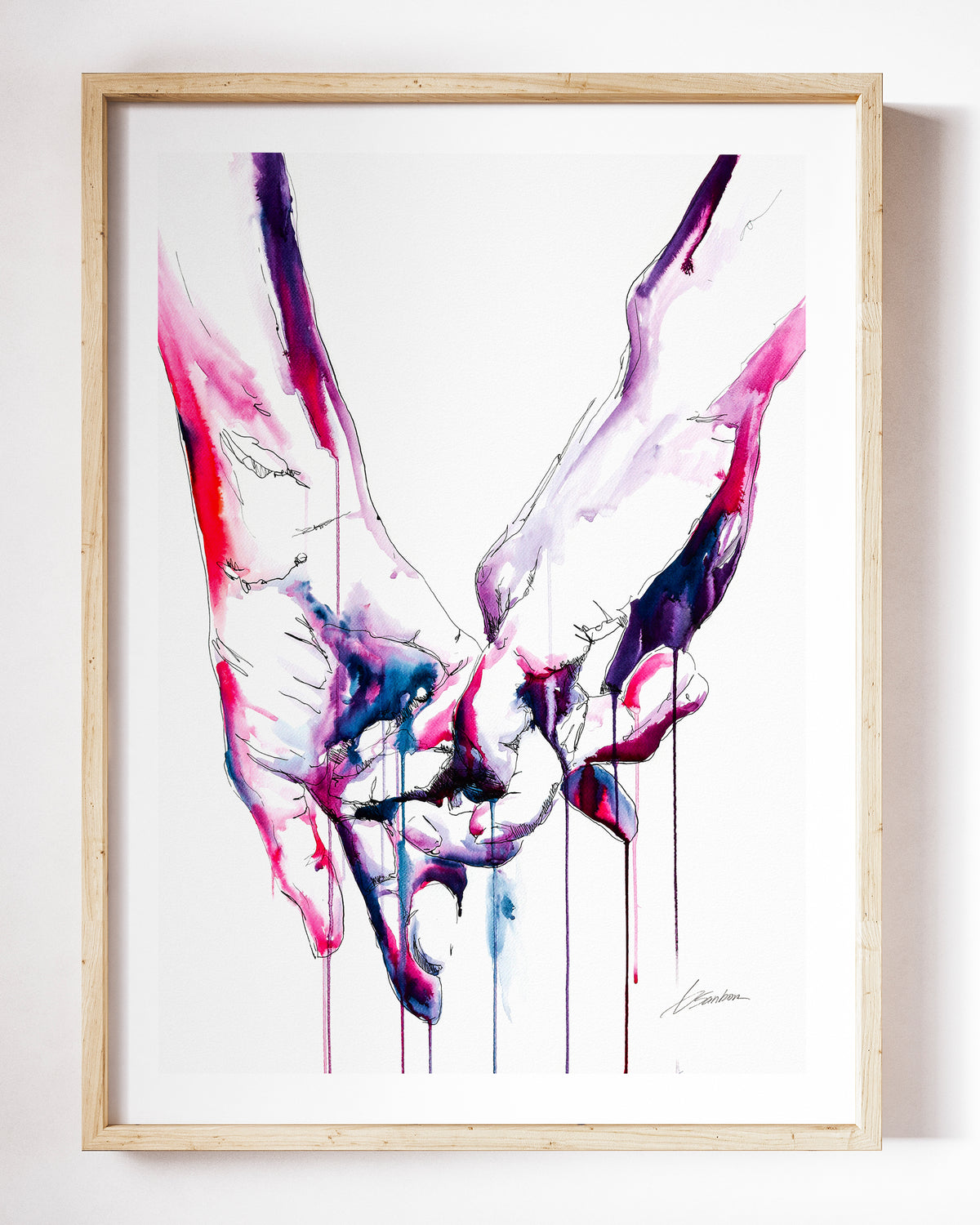 Simple Gesture of Love watercolor art print by Brenden Sanborn, two men's hands reaching for each other, in pink, violet and red, shown in a light wood frame on a white wall
