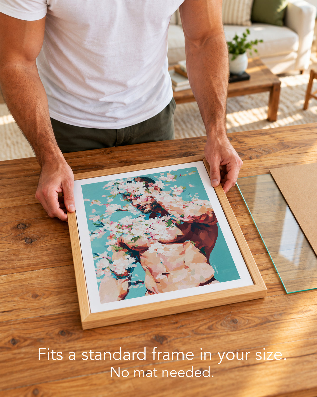 A man placing the Soft Riot paper art print with a white border into a standard wood frame, no mat needed
