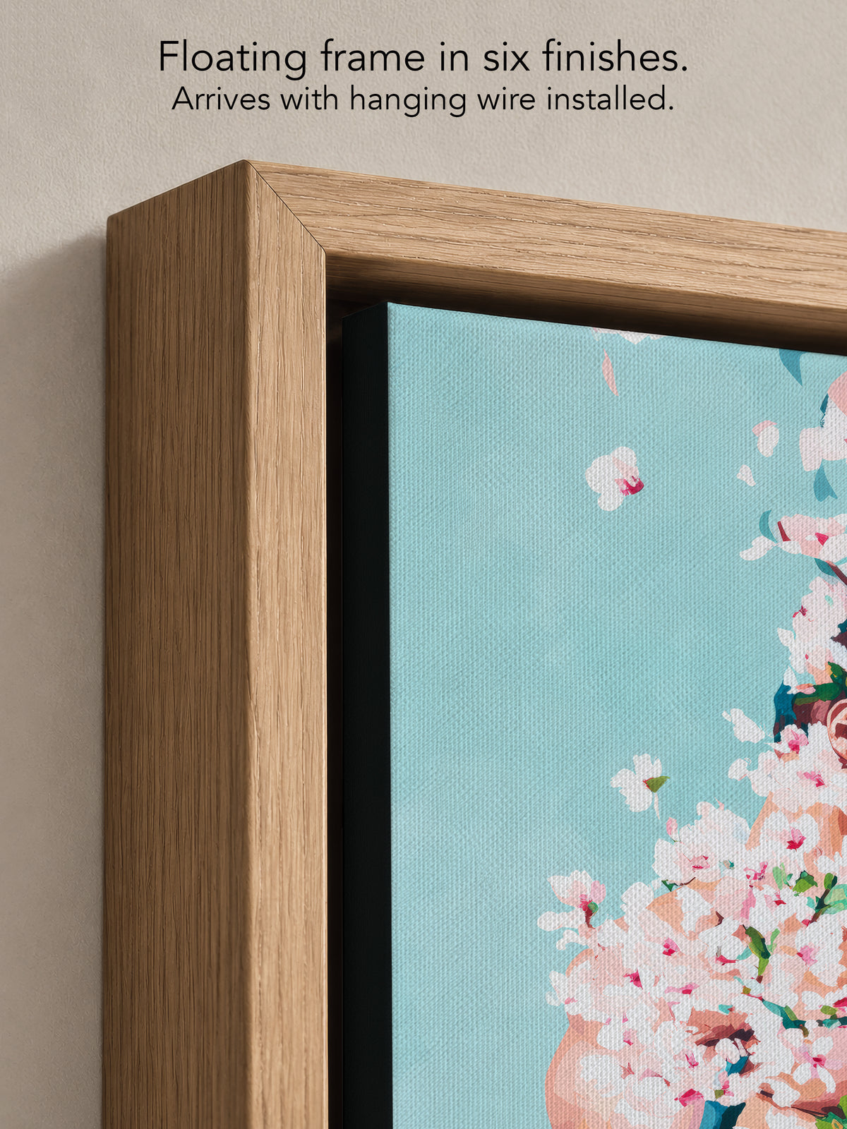 Close up corner of Under Branches in a natural oak floating frame, with black canvas edges and hanging wire installed