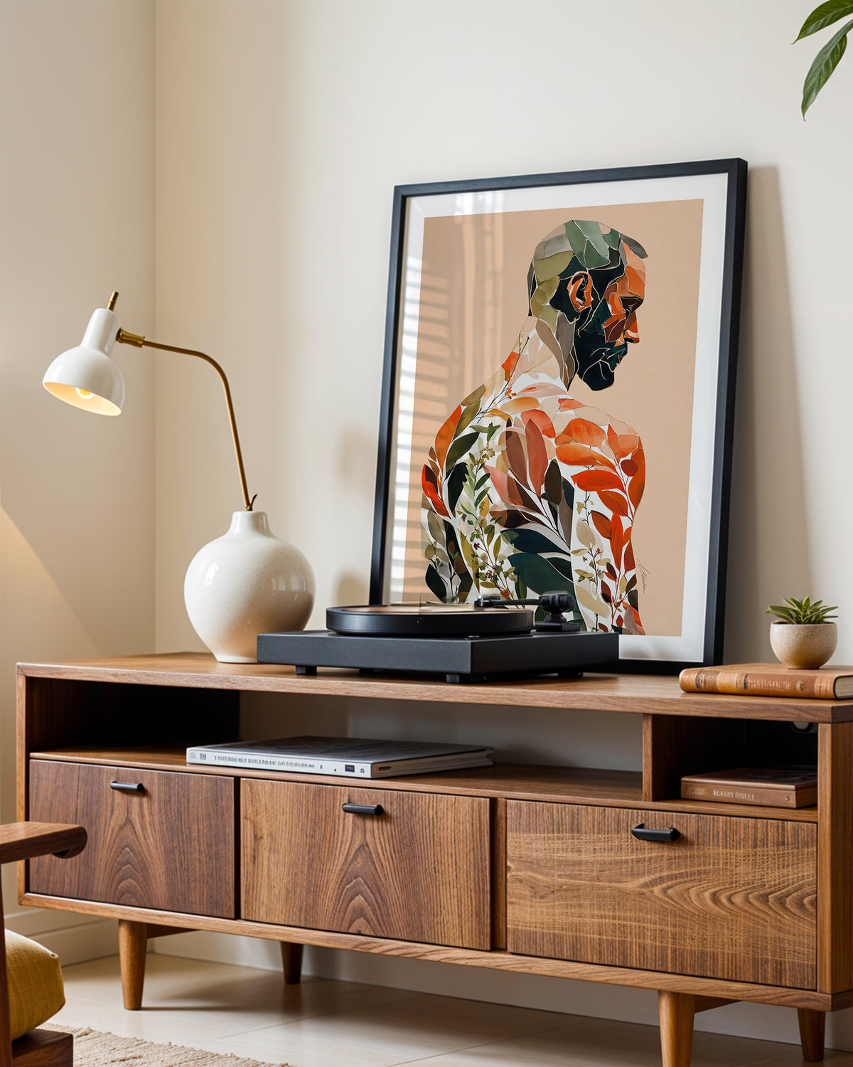 Autumn Inside art print in a black frame leaning on a walnut sideboard beside a record player