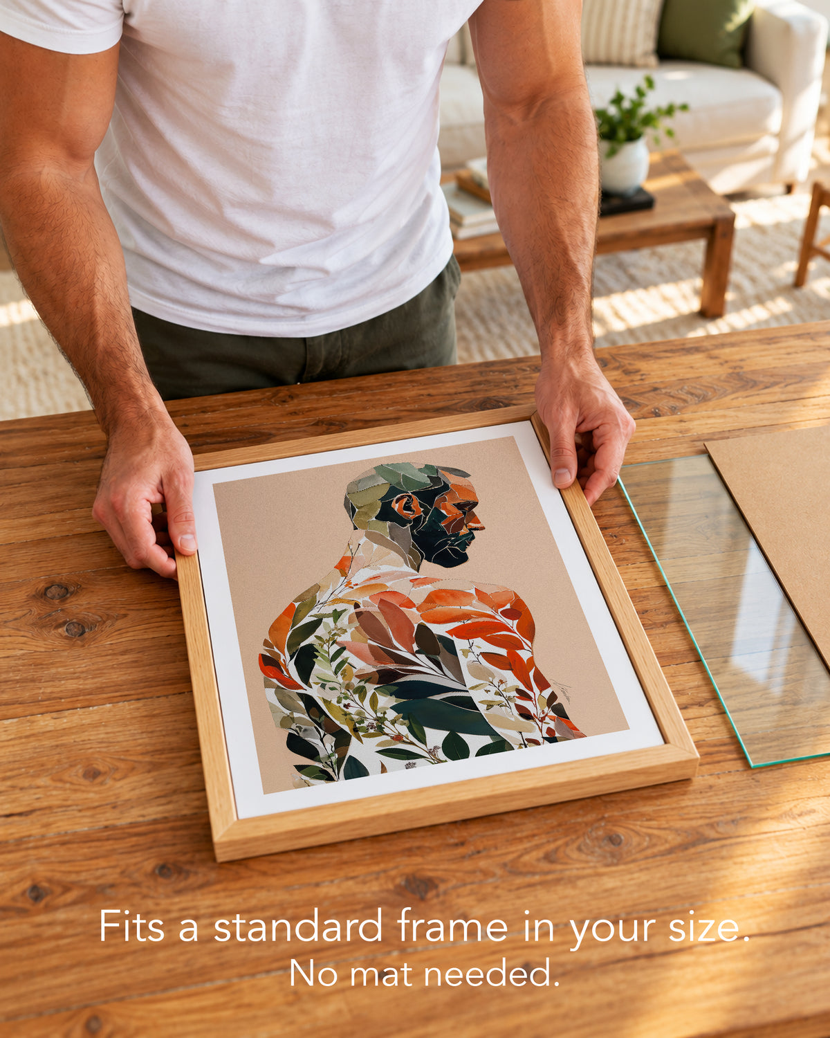 A man placing the Autumn Inside paper art print with a white border into a standard wood frame, no mat needed