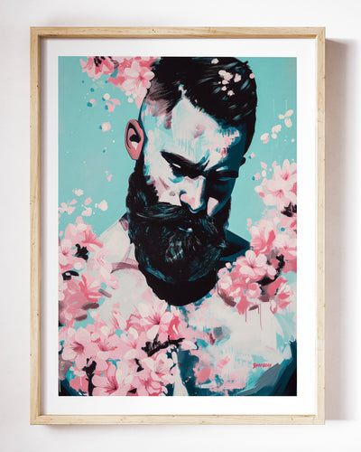 Blush Season art print by Brenden Sanborn, a bearded man looking down, surrounded by pink cherry blossoms, shown in a light wood frame