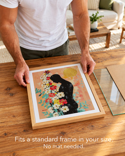 A man placing the Bowed Light paper art print with a white border into a standard wood frame, no mat needed