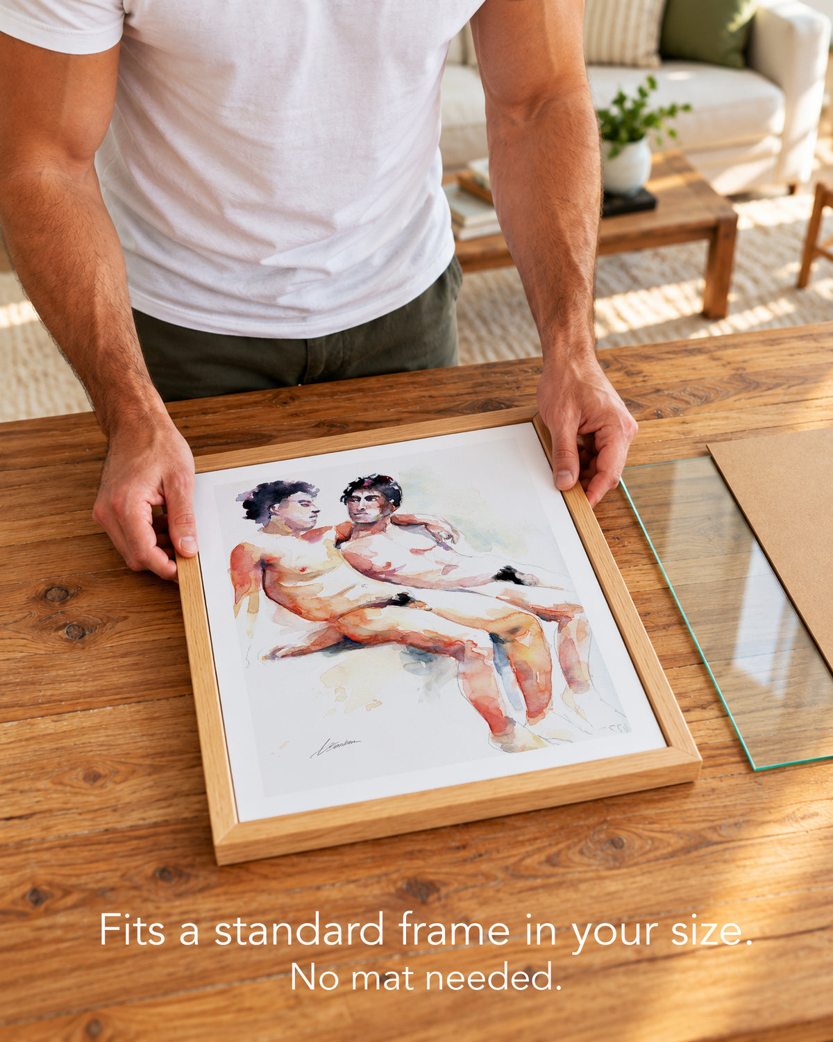 A man placing the Heavenly Moment paper art print with a white border into a standard wood frame, no mat needed