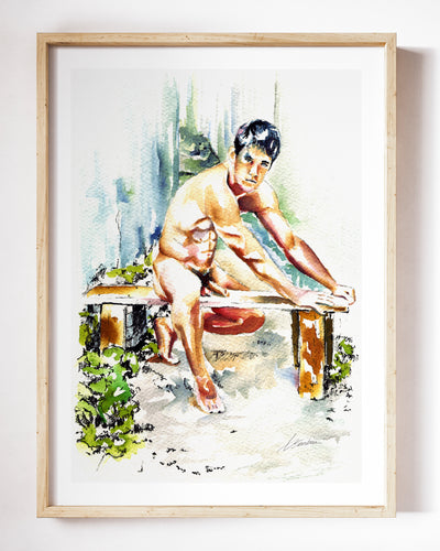 Garden Bench art print by Brenden Sanborn, a nude man seated on a wooden garden bench surrounded by greenery, shown in a light wood frame