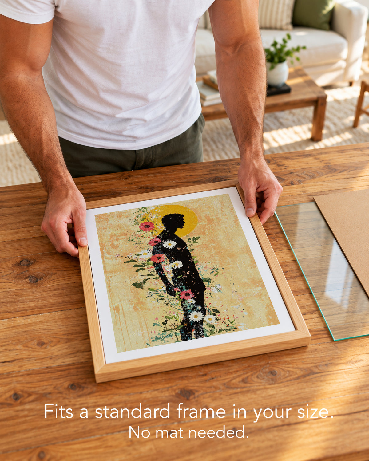 A man placing the Inner Garden paper art print with a white border into a standard wood frame, no mat needed