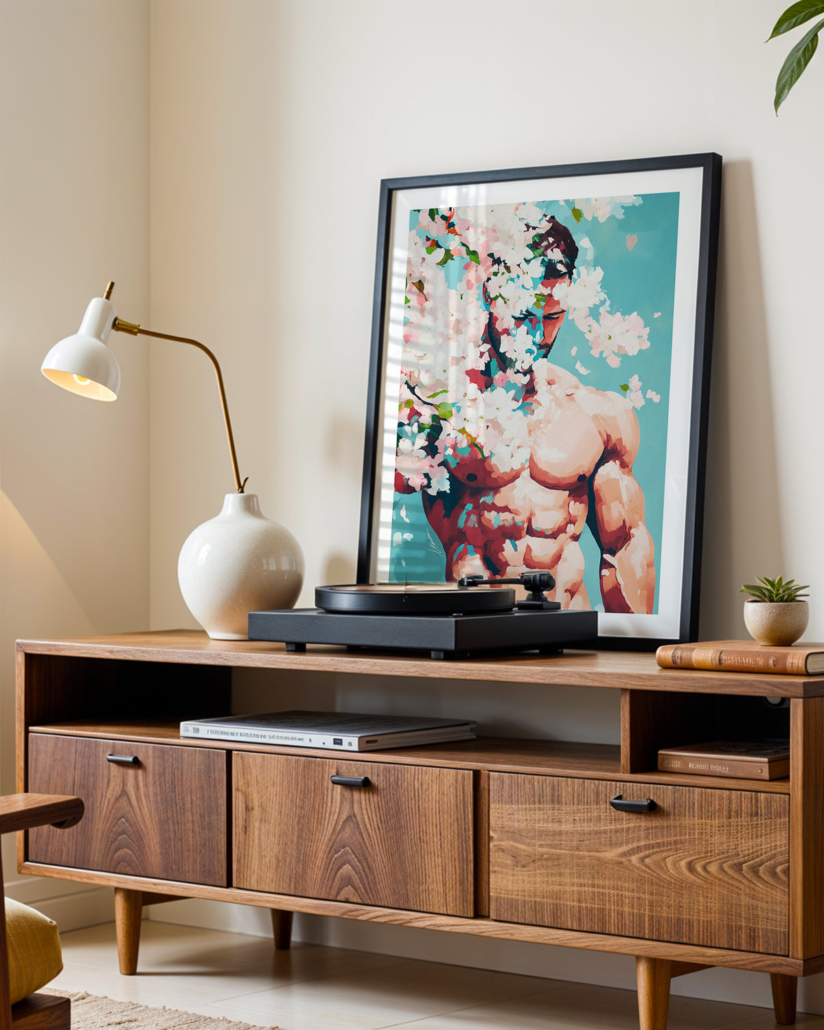 Pale Weather art print in a black frame leaning on a walnut sideboard beside a record player