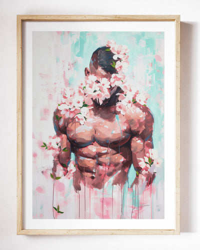 Pink Static art print by Brenden Sanborn, a muscular torso with blossoms across the face and pink color dripping behind him, shown in a light wood frame