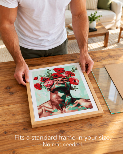A man placing the Red Hush paper art print with a white border into a standard wood frame, no mat needed