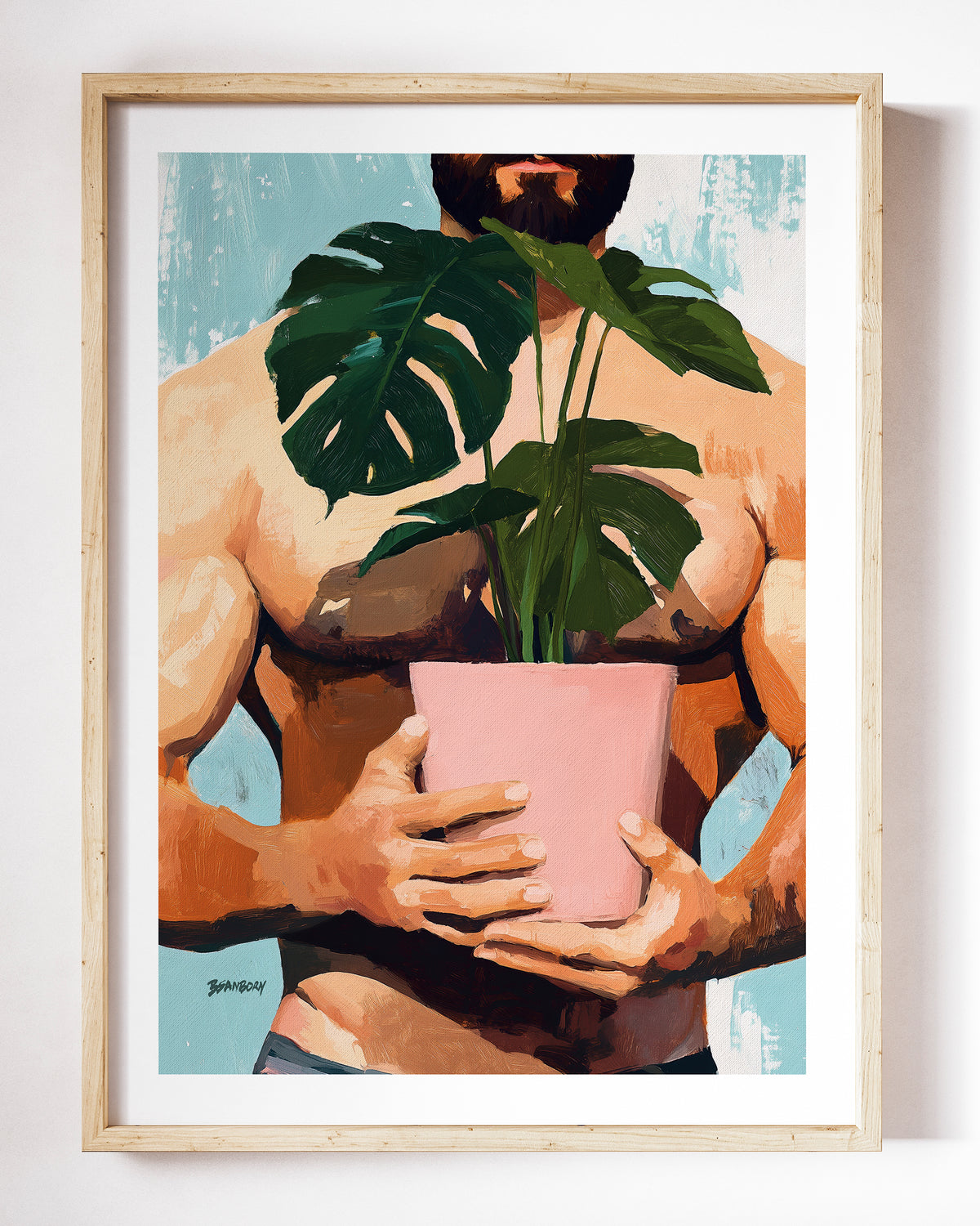 Small Jungle art print by Brenden Sanborn, a shirtless man holding a large monstera plant in a pink pot, shown in a light wood frame