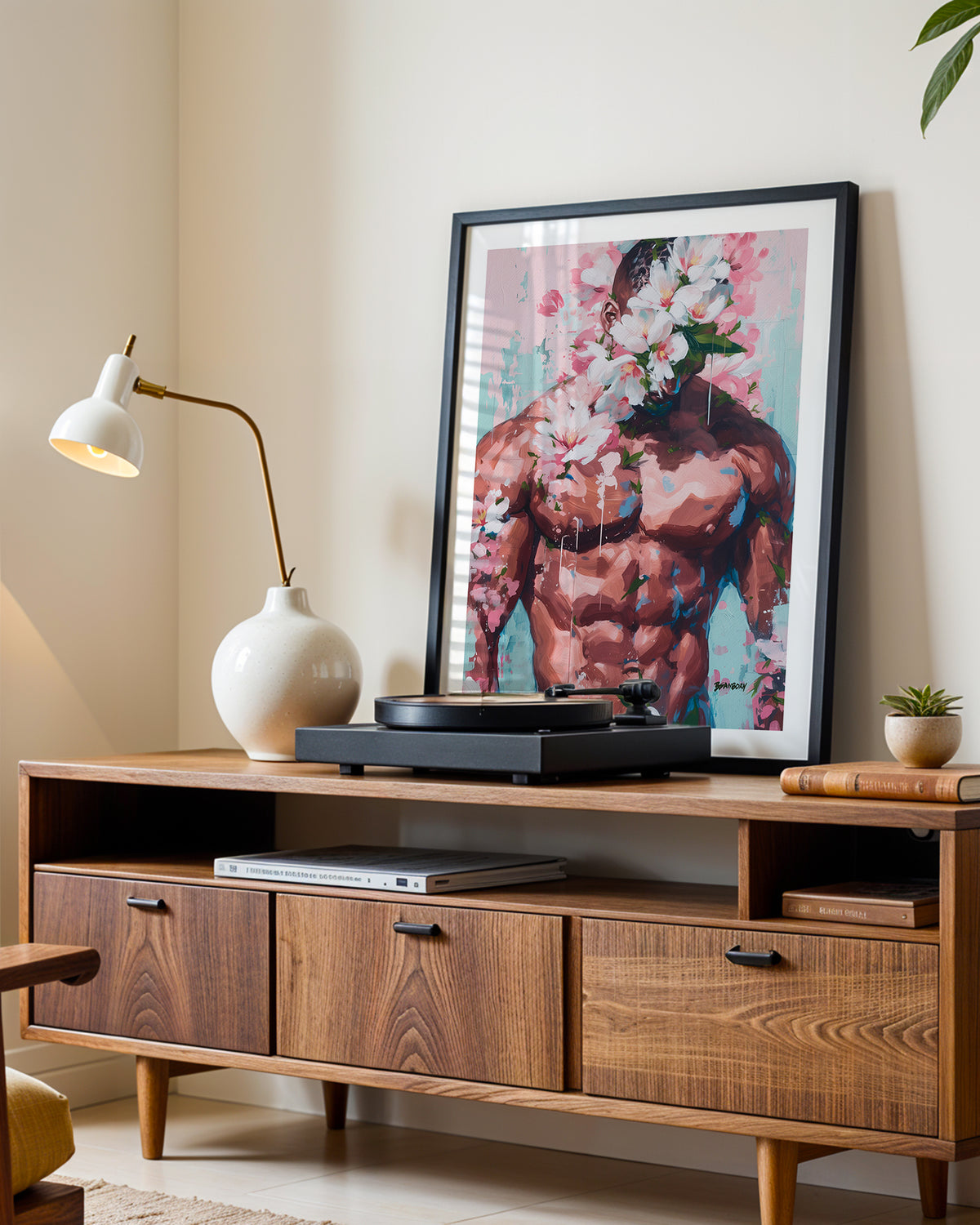 Sweet Drift art print in a black frame leaning on a walnut sideboard beside a record player