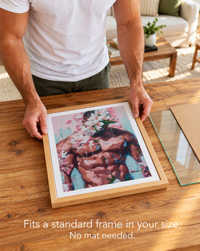A man placing the Sweet Drift paper art print with a white border into a standard wood frame, no mat needed