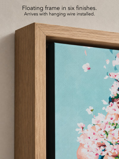 Close up corner of Under Branches in a natural oak floating frame, with black canvas edges and hanging wire installed