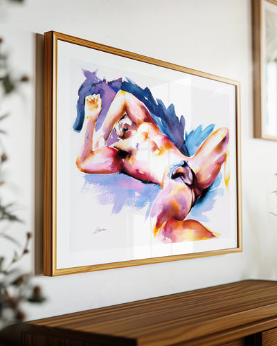 Wide Awake art print by Brenden Sanborn, a nude man sprawled on his back in violet, blue and orange washes, shown in a light wood frame on a sideboard